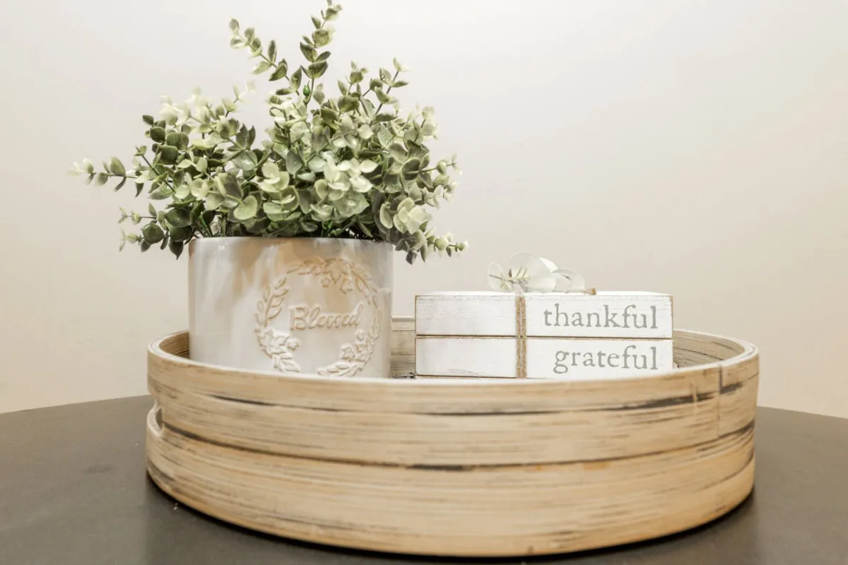 A cozy interior space featuring a decorative plant, a wooden tray, and inspirational blocks. The arrangement invites moments of relaxation and togetherness, with thoughtful details that suggest a welcoming atmosphere for families to gather, play games, or unwind after a day of exploration.